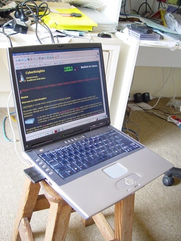 A compact mini PC tower on a desk beside a keyboard